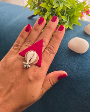Red fabric with cowrie finger ring