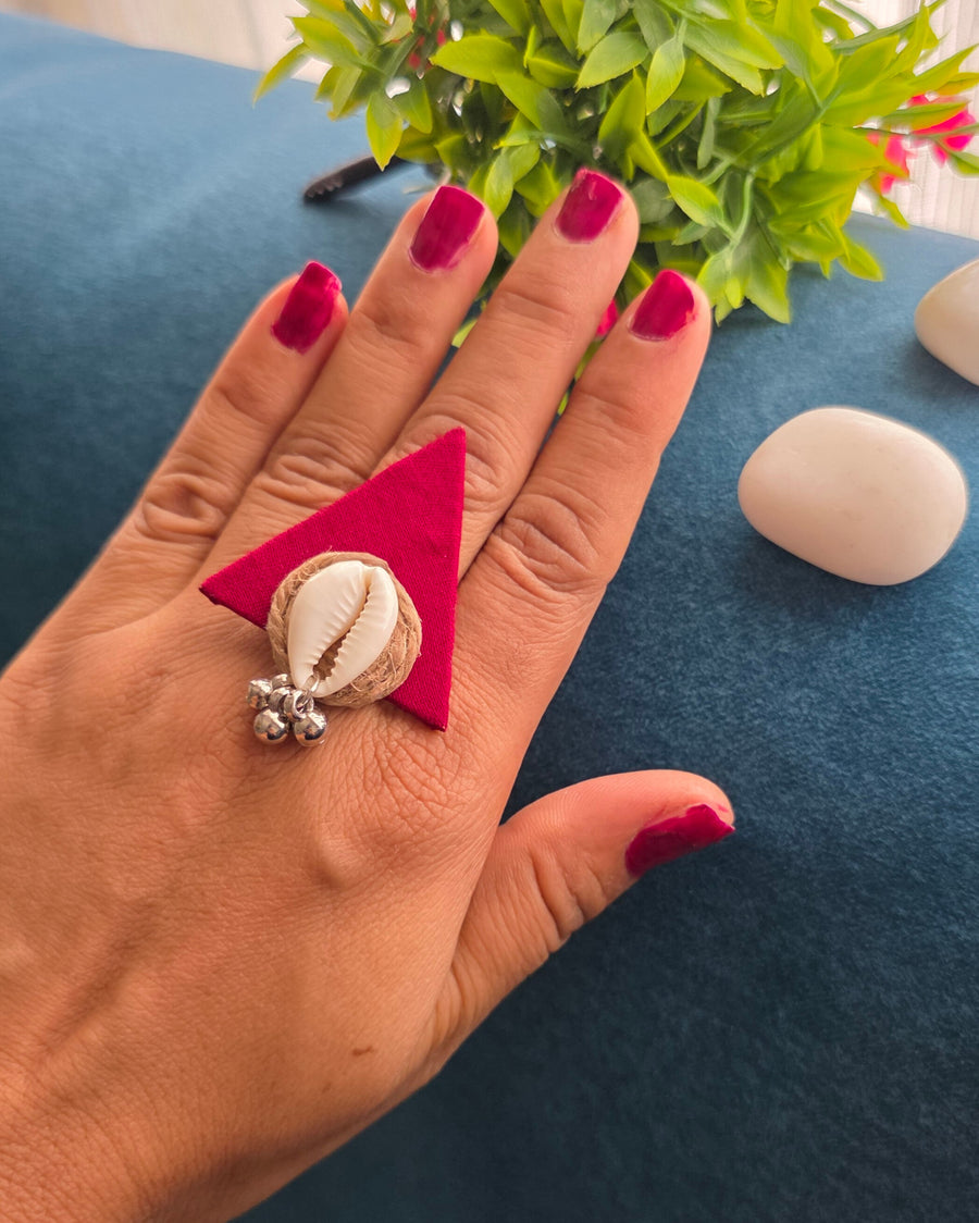 Red fabric with cowrie finger ring